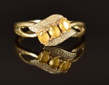 A 9ct gold ring set with three citrines, size Q, 2.3g