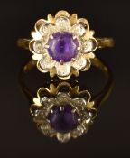 An 18ct gold ring set with an amethyst and diamonds in a flower setting, size J, 3.9g