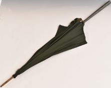 Silver handled umbrella, the likely Chinese silver handle having embossed foliate decoration,