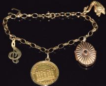 A 9ct gold charm bracelet with four 9ct gold charms and a gold charm marked 986, 12.6g