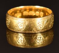 A 22ct gold ring/ wedding band with engraved decoration, size P/Q, 5.8g