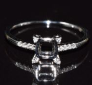 An 18ct gold ring mount set with diamonds to the shoulders and setting, size M