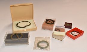 Four Roman annular brooches including a banded silver wire example, brass armlet and a bronze ring