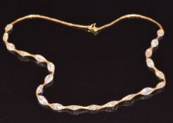 A 9ct gold necklace set with zircon, 7.7g