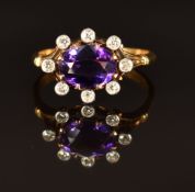 A c1900 18ct gold ring set with an oval cut amethyst and diamonds, size L, 3.5g