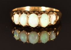 A 9ct gold ring set with five opals, size O, 3.9g