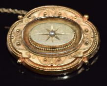 Victorian yellow metal brooch set with a pearl, with glass compartment verso, 10.8g