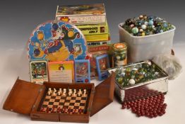 A collection of marbles, puzzles and table top games including Blow Football, Top Trumps and Nim.