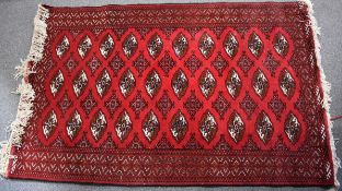 Red ground rug, 210 x 129cm