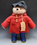Gabrielle Designs Paddington Bear with red jacket, navy hat, blue Wellington boots and label '