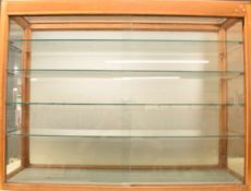 Vintage Dinky Toys style display or retail cabinet with glass shelves and sliding door