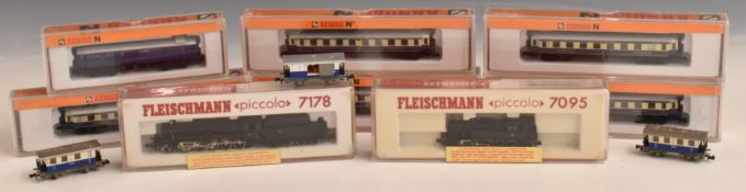 Eleven Fleishmann and Arnold N gauge model railway locomotives and coaches, eight in original boxes.