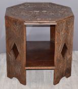 Carved octagonal hardwood table with tribal scenes to top, W63cm, H62cm