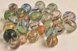 Twenty-nine vintage glass marbles all with multi-coloured latticinio decoration, largest 23mm in