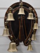 Campanology set of eight bells on horseshoe wall bracket