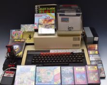 A vintage BBC computer including disk drive, mouse and a selection of games.