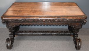 Victorian carved oak library table with moulded frieze, raised on twin ornate supports and two
