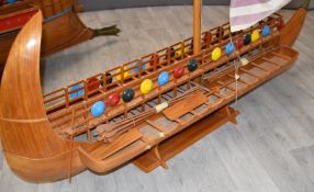 A scratch build model of a Phoenician Galley, early Bireme, with singe mast sail, oars and