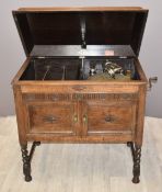 Gilbert c1930s wind up parlour gramophone in carved oak case, standing on barley twist legs, W83 x