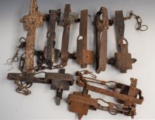 Nine vintage animal traps some maned including examples stamped 'Sidebotham's Genuine', 'Li-Lo', '