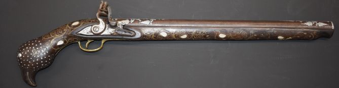 Eastern large flintlock pistol with butt carved in the form of a bird, with frame inlaid all over