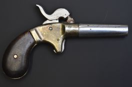 Unnamed percussion hammer action bank firing or cap pistol with brass frame, shaped wooden grips and