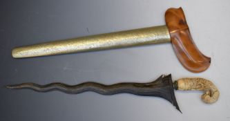 Ornately carved ivory handled Kris dagger with 35cm blade and sheath. PLEASE NOTE ALL BLADED ITEMS