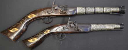 A pair of flintlock blunderbuss pistols each with inlaid and bone and wire decoration, white metal