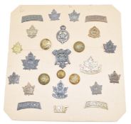 A carded display of approximately twenty five WW1 Canadian Army insignia including artillery