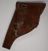 Brown leather revolver or pistol holster with brass mounts, 35cm long.