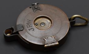 A brass rotary percussion cap dispenser with single suspension loop engraved to one side 'JRW' and