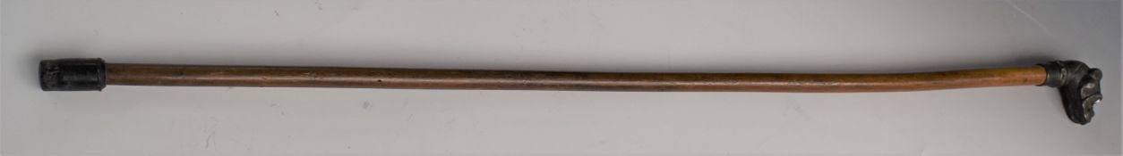 A vintage walking stick with bronze dog head handle