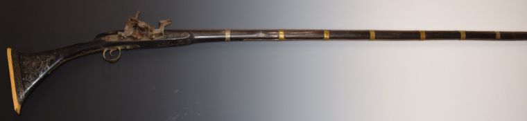 Eastern flintlock gun with engraved lock, hammer, barrel bands, trigger guard and barrel, silver