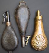Three shot or powder flasks, one G & J W Hawksley copper and brass with shell decoration, one