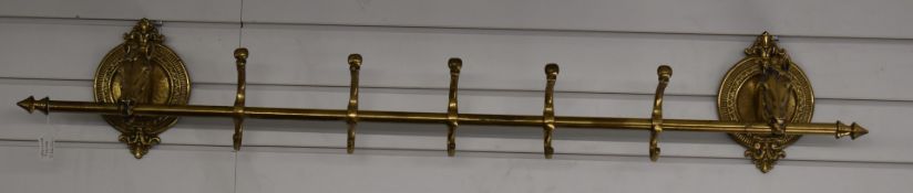 A figural horse brass coat rail, H23 x L132cm