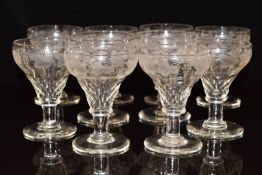A set of ten cut and engraved glass drinking glasses, each 14cm tall.