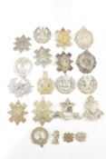 A collection of approximately twenty British Army Scottish headdress badges including the