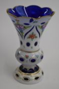 19thC overlaid and cut glass vase with white casing over blue ground, hand decorated with flowers