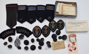 A collection of Queen's Institute of District Nursing badges and buttons, including a hallmarked
