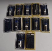 Ten Beretta shotgun chokes together with two choke tube wrenches, all unused in original packaging.