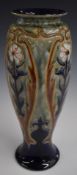 Royal Doulton pedestal vase with flower decoration, Frank Butler monogram to base, H29cm