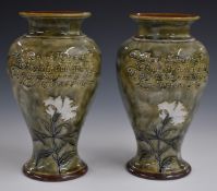 Pair of Royal Doulton pedestal vases decorated with flowers and with motto verso, both