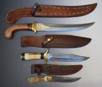 Three modern Damascus bladed knives all with leather sheaths, largest blade 31cm. PLEASE NOTE ALL