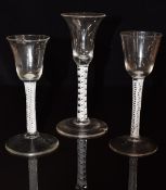 Three 18thC drinking glasses all with cotton twist stems, largest 16.5cm tall.