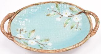 Late 19thC two handled oval majolica dish with floral decoration, length 38cm