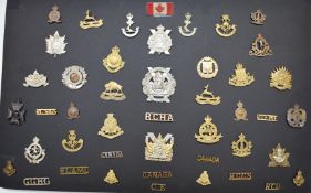 Approximately forty Canadian Army metal badges and insignia including Glengarry Fencibles,