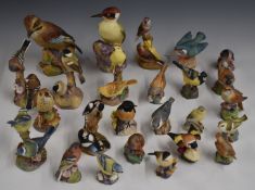 A large collection of Royal Worcester bird figures including woodpecker, jay, blue tits, chaffinches