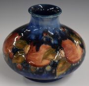 Moorcroft signed squat pedestal vase decorated in the Pomegranate pattern, with impressed 'Maker