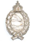 WW1 Prussian pilot's badge depicting Antoinette monoplane above buildings, surrounded by a wreath