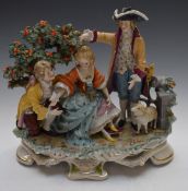 A large continental figural group of a lady with two suitors beneath an apple tree